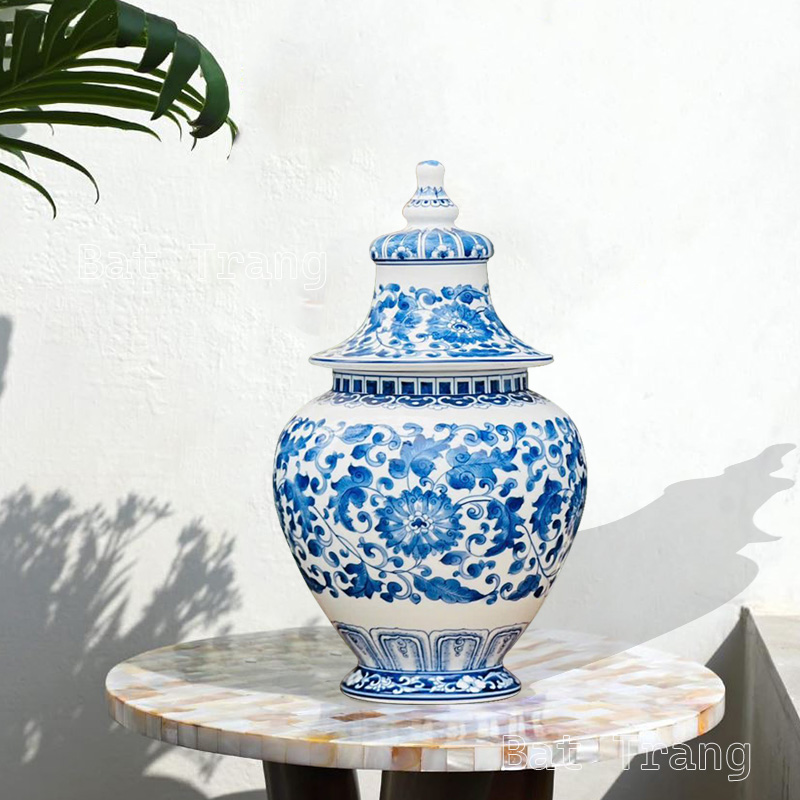 A handcrafted blue and white ginger jar vase featuring floral vine patterns from Bat Trang