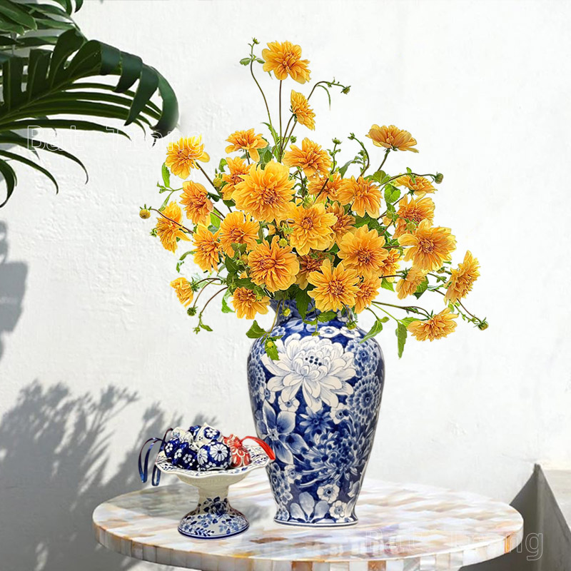 Blue and White Decorative Vase on Table with Yellow Dahlia Flowers